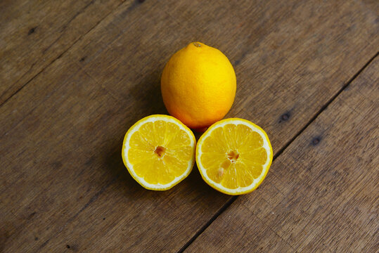 Yellow Fresh Lemon Slice Over Wooden Background