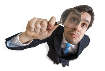 Young man is looking through magnifying glass. Isolated on white background.