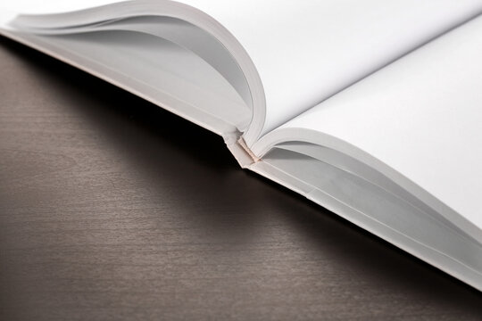 Blank pages of opened book on black background