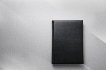 Blank cover of closed book on light background