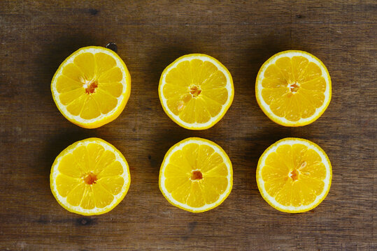 Yellow Fresh Lemon Slice Over Wooden Background