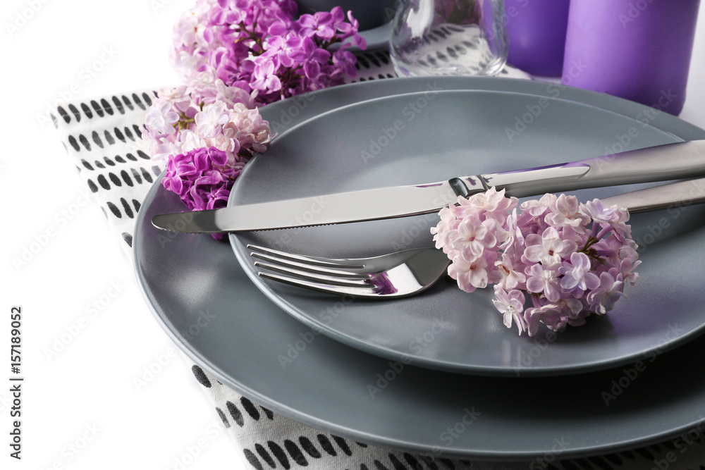 Wall mural beautiful festive table setting with lilac flower decor on white background, closeup