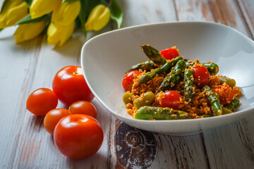 Vegan salad with asparagus tomato and bulgur