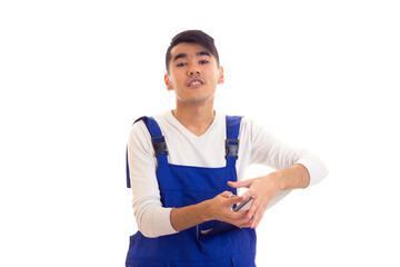 Young man in blue overall holding pen and folder