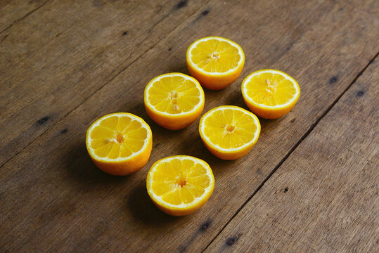 Yellow Fresh Lemon Slice Over Wooden Background