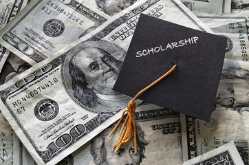 Scholarship graduation cap on cash