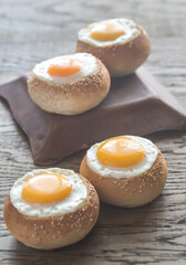 Egg-in-a-hole buns on the wooden board