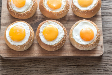 Egg-in-a-hole buns on the wooden board