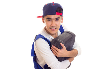 Young man in overall holding toolbox