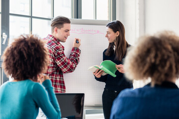 Involved students sharing ideas and opinions while brainstorming during an interactive class in the...