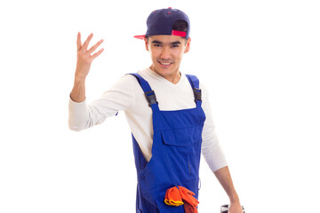 Young man in overall holding toolbox