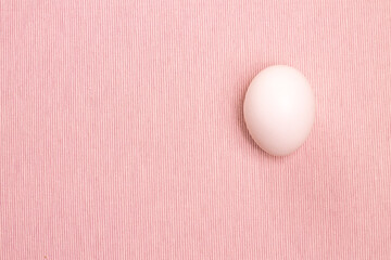 Top view of white egg on the pink