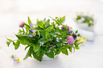 Bouquet of fresh herbs on white table