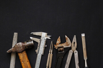 Working tools on black background top view. set instruments for hand work and fixing. Construction...