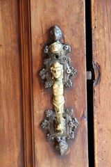 Old vintage Italian hand door knocker of 
Basilica San Nicolo, Lecco Italy 