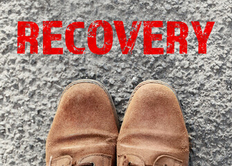 Feet in shoes on asphalt background