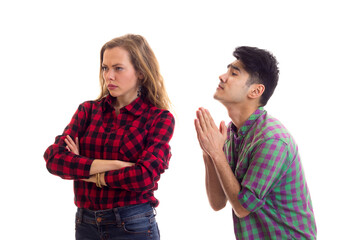 Young couple in plaid shirts arguing 