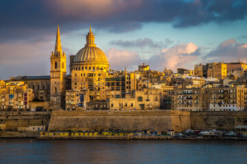 Fototapeta na wymiar Valletta, Malta - Golden hour at the famous St.Paul's Cathedral and the city of Valletta