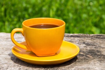 Coffee cup on rustic wooden table outdoor