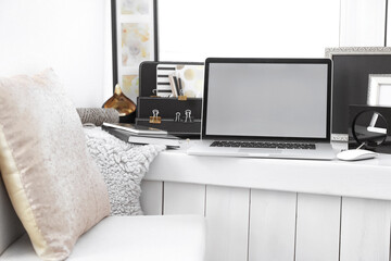 Fototapeta premium Creative workplace with laptop on windowsill in modern room