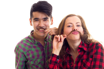 Young couple in plaid shirts with moustache of hair