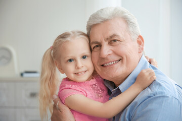 Portrait of happy senior man with granddaughter