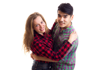 Young couple in plaid shirts hugging