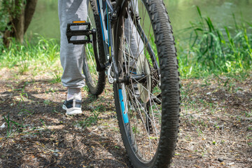 Relax on a mountain bike ride along the forest path. Sports and the concept of active life in the summer. Horizontal frame