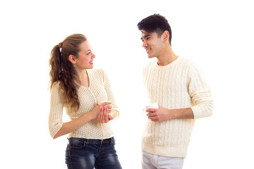 Young couple holding cups and talking