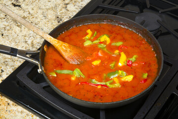 Simmering marinara sauce and vegetables