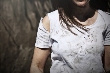 Poor woman in dirty clothes outdoors