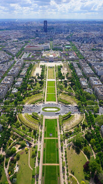 Aerial view of Champ de Mars gardens from Eiffel tower with beautiful scattered clouds, Paris, France