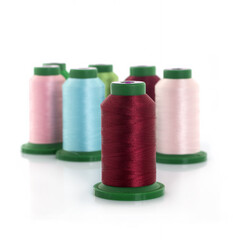 Colored threads on reels on a white background
