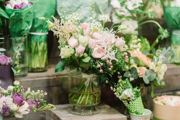 Bouquet of roses. petals and other flovers in vase