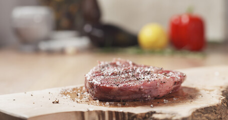 raw rib eye steak with spices, wide photo