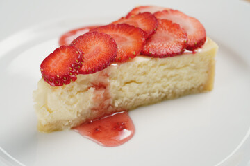 cheesecake with strawberry on plate closeup, shallow focus