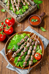 Chicken hearts on a barbecue sticks topped with sesame seeds