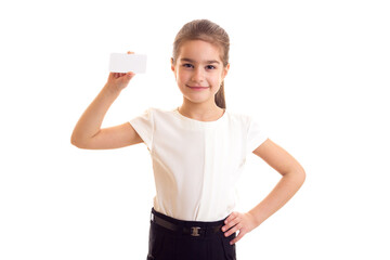 Little girl in white T-shirt holding white card