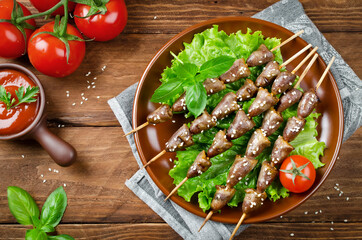 Chicken hearts on a barbecue sticks topped with sesame seeds