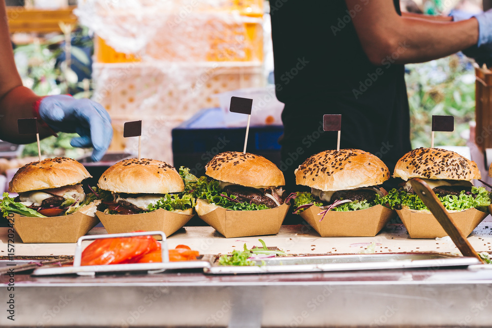 Wall mural fresh delicious grilled burgers on the table. burger festival