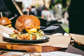 Fresh tasty grilled meat burger on the table. Selective focus