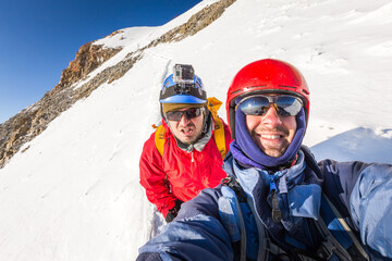 Fototapeta na wymiar Two climbers mountaineers smiling mountain ridge Huayna Potosi Bolivia.