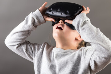 girl watching with VR device and feeling surprise