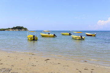 Boats on the sea waiting to be hired by tourists near Sidari - Corfu island in Greece.