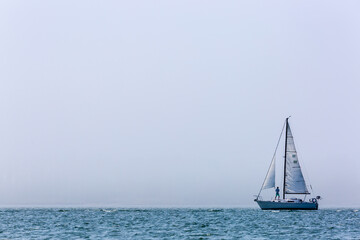 Fototapeta premium Sailing in misty lake