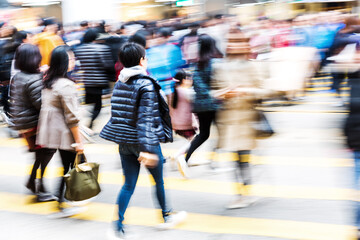 crowds of people crossing a city street