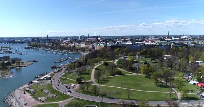 Kaivopuisto, Cinema 4k aerial view of a flight around brunnsparken, on a sunny summer day, in Helsinki, Finland
