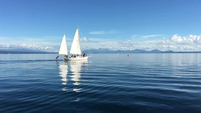 White yacht sailing over Lake Taupo in the North Island of New Zealand