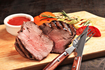 Medium Rare Filet mignon steak on wooden board, selected focus