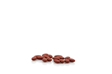 Brown pills isolated on white background.
